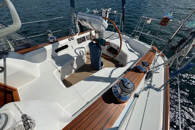 Slide: The Image of Cockpit of 2002 Sabre 402 sailboat with wooden accents and steering wheel on open water. - 17