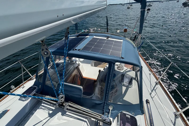Slide: The Image of Sailboat Sabre 402 (2002) with solar panels on deck, sailing on open water. - 25