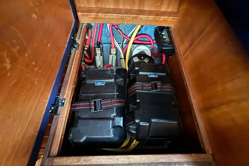 Slide: The Image of Battery compartment of a 2002 Sabre 402 sailboat, featuring wiring and secure battery boxes. - 42