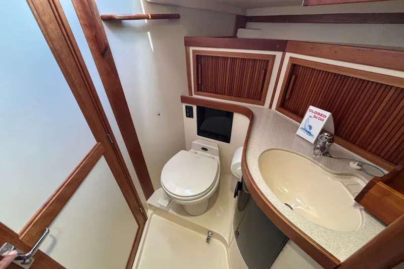 Slide: The Image of Bathroom interior of 2002 Sabre 402 yacht with wooden accents and modern fixtures. - 63
