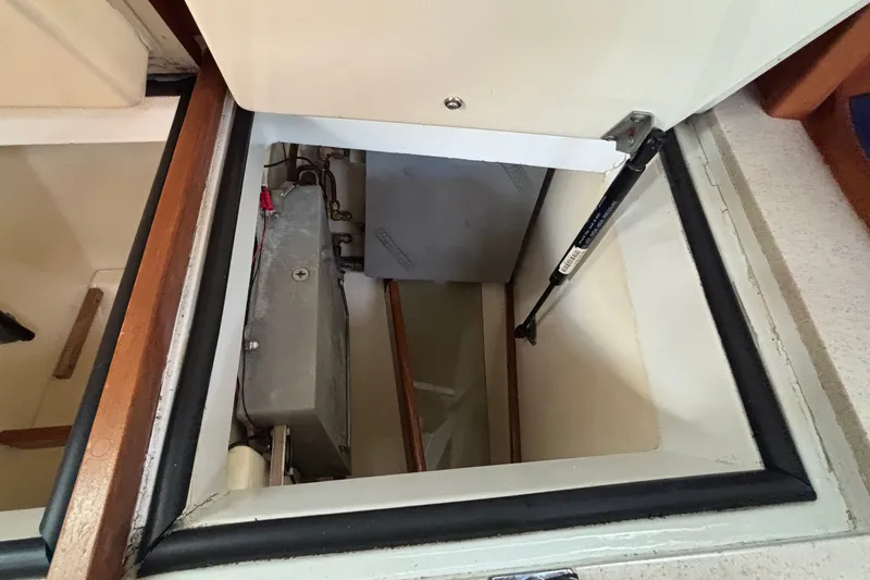 Slide: The Image of Open hatch of a 2002 Sabre 402 boat, revealing interior storage compartment. - 75