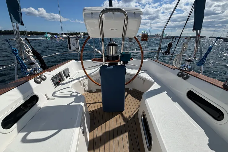 Slide: The Image of Cockpit of a 2002 Sabre 402 sailboat with wooden wheel and ocean view. - 16