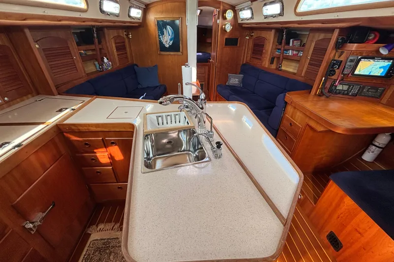 Slide: The Image of Luxurious 2002 Sabre 402 yacht interior with modern kitchen and cozy seating area. - 64