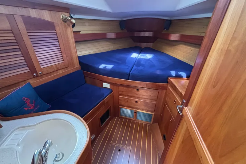 Slide: The Image of Luxurious 2002 Sabre 402 yacht cabin with wood finish and cozy blue bedding. - 56