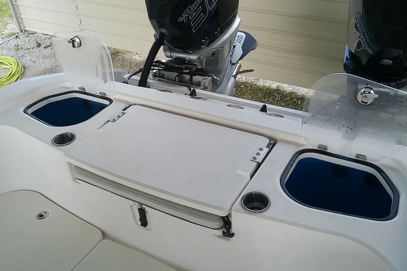 Slide: The Image of 2022 Sea Cat 260 boat interior with dual engines and storage compartments. - 47