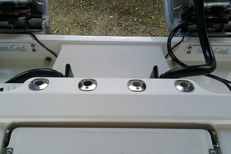 Slide: The Image of 2022 Sea Cat 260 boat deck with rod holders and engine controls. - 52