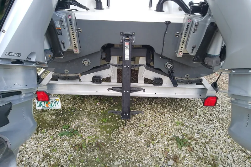 Slide: The Image of Rear view of a 2022 Sea Cat 260 boat with dual outboard motors. - 21