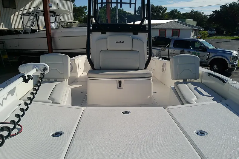 Slide: The Image of The image shows a 2022 Sea Cat 260 boat with a spacious deck and seating areas. - 12