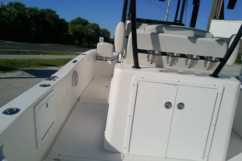 Slide: The Image of 2022 Sea Cat 260 boat interior with rod holders and storage compartments. - 17