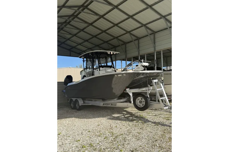 Slide: The Image of 2022 Sea Cat 260 boat on trailer under metal shelter. - 1