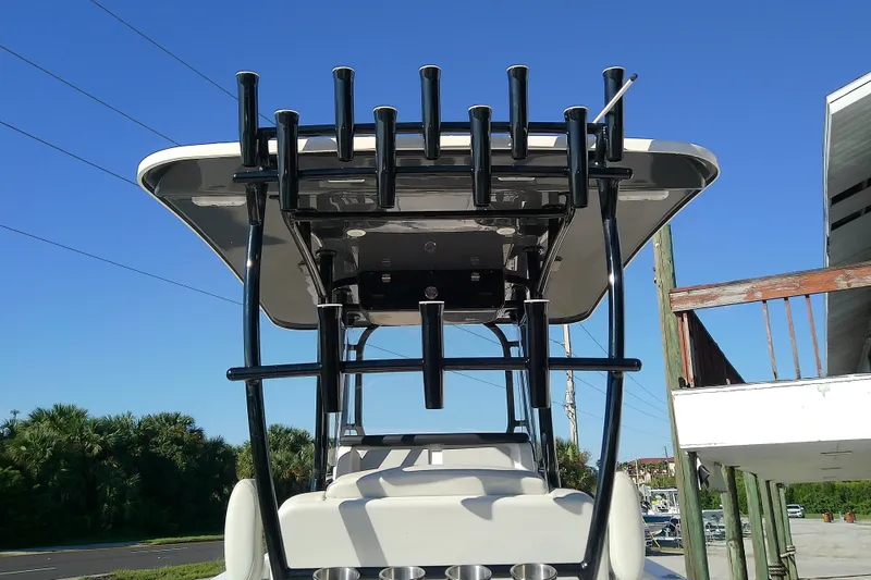 Slide: The Image of 2022 Sea Cat 260 boat with rod holders and T-top against clear blue sky. - 15