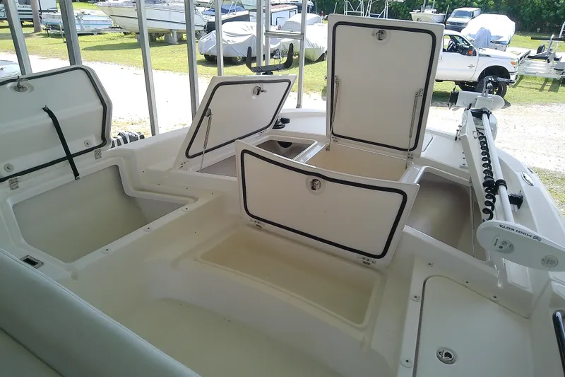 Slide: The Image of 2022 Sea Cat 260 boat with open storage compartments and Minn Kota trolling motor. - 72