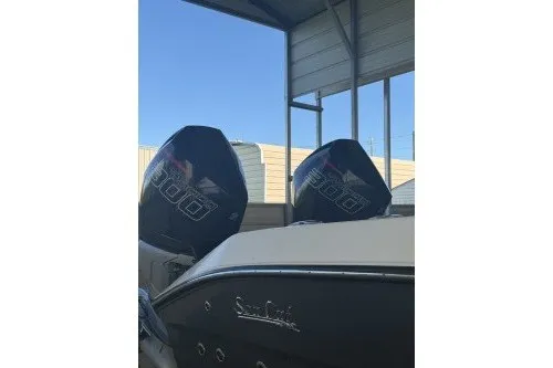 Slide: The Image of 2022 Sea Cat 260 boat with dual outboard engines under a metal canopy. - 49