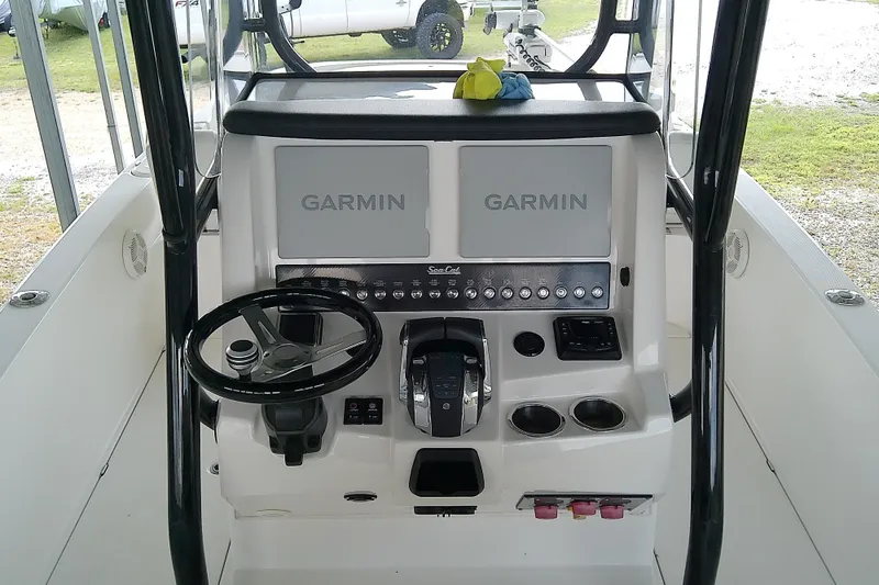 Slide: The Image of 2022 Sea Cat 260 boat dashboard with dual Garmin displays and steering wheel. - 60
