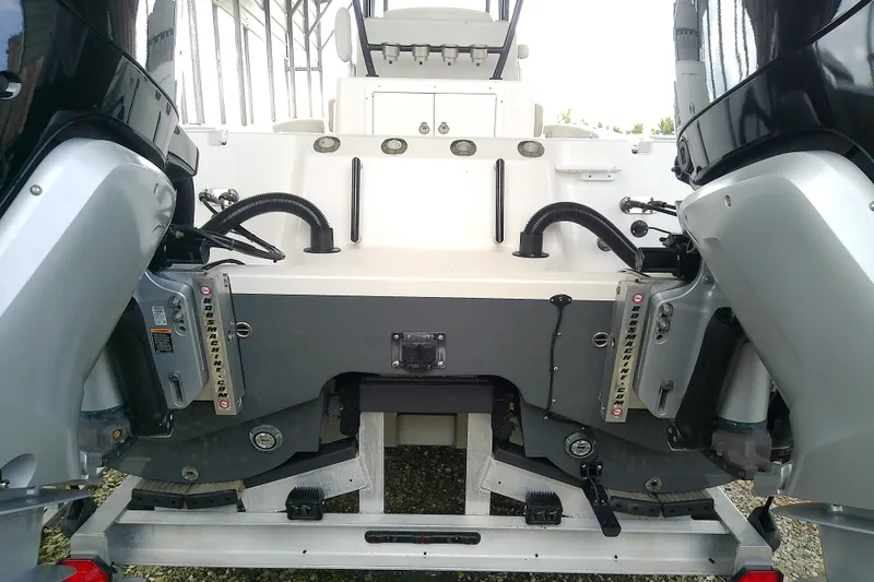 Slide: The Image of Rear view of a 2022 Sea Cat 260 boat with dual outboard motors. - 23