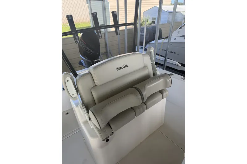 Slide: The Image of Sea Cat 260 boat seating, 2022 model, featuring comfortable white upholstery and rod holders. - 64