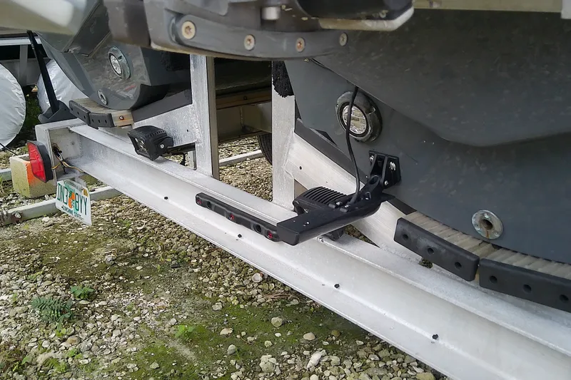 Slide: The Image of 2022 Sea Cat 260 boat trailer detail with license plate and step ladder. - 15