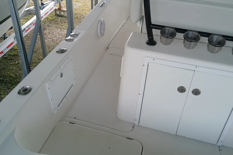 Slide: The Image of Interior of 2022 Sea Cat 260 boat with storage compartments and cup holders. - 56