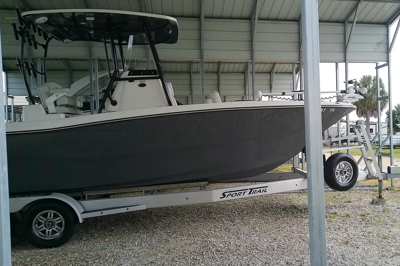 Slide: The Image of A 2022 Sea Cat 260 boat on a trailer in a covered area. - 2