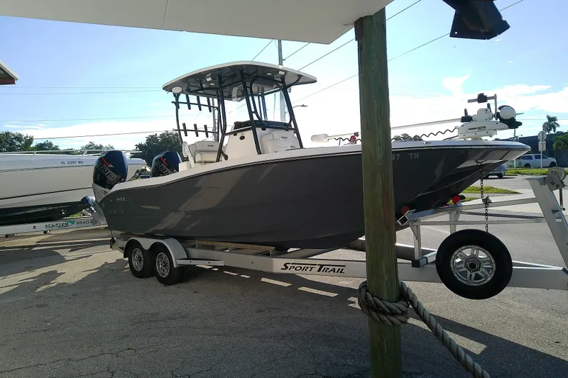 Slide: The Image of 2022 Sea Cat 260 boat on trailer, parked outdoors under clear sky. - 6