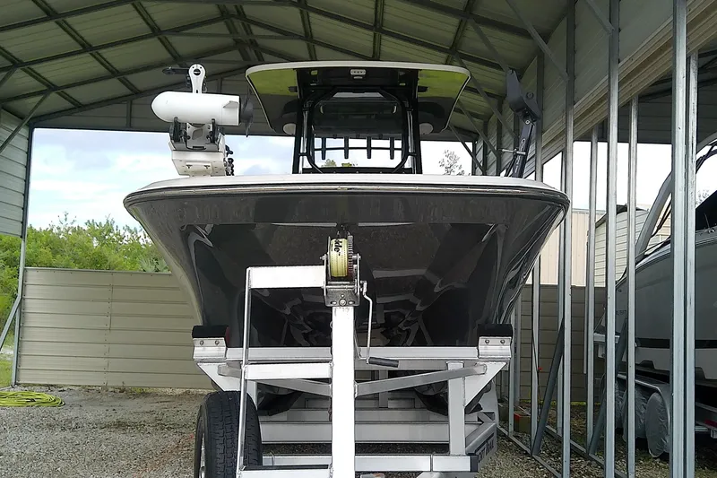 Slide: The Image of A 2022 Sea Cat 260 sits on a trailer in a covered area. - 4