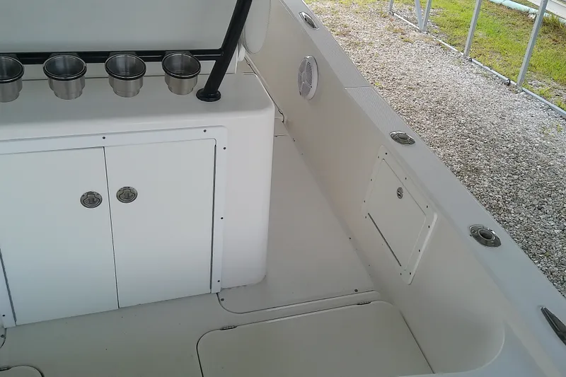 Slide: The Image of Interior of 2022 Sea Cat 260 boat with storage compartments and cup holders. - 55