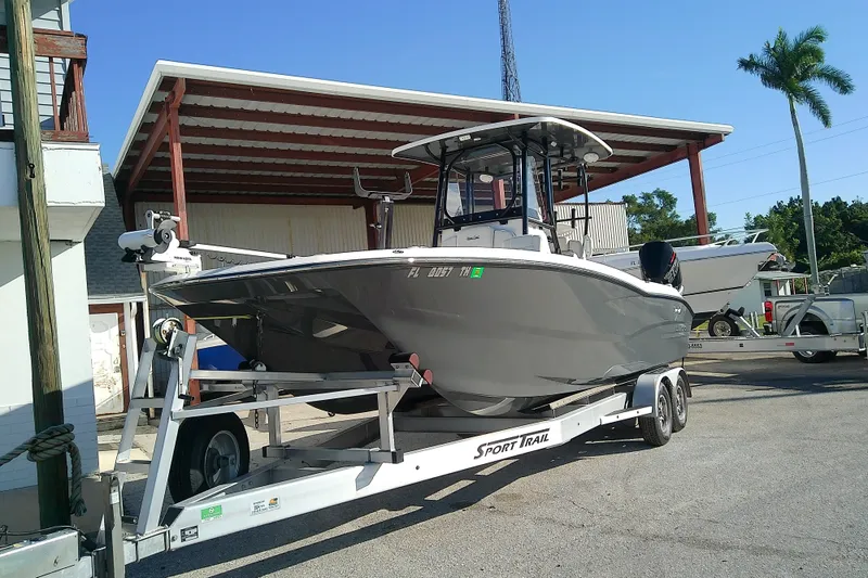 Slide: The Image of 2022 Sea Cat 260 boat on trailer under a metal canopy, sunny day. - 5