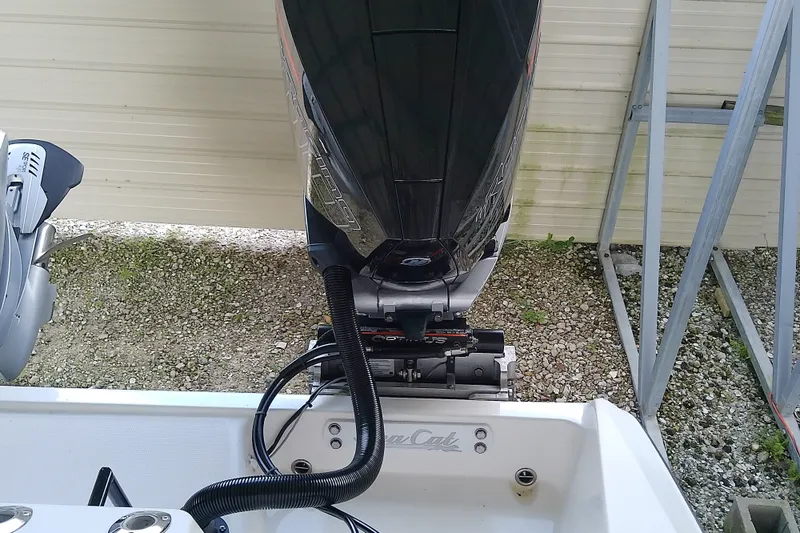 Slide: The Image of Outboard motor on a 2022 Sea Cat 260 boat, parked on gravel. - 50