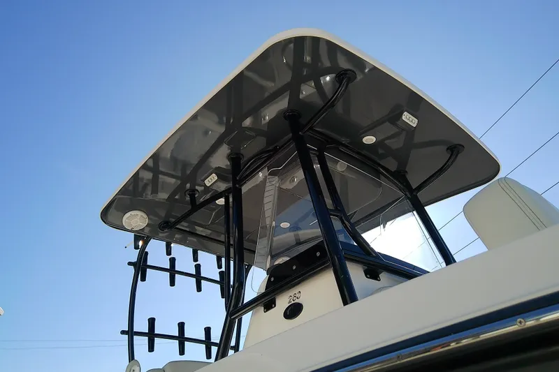 Slide: The Image of 2022 Sea Cat 260 boat with sleek T-top design against clear blue sky. - 11