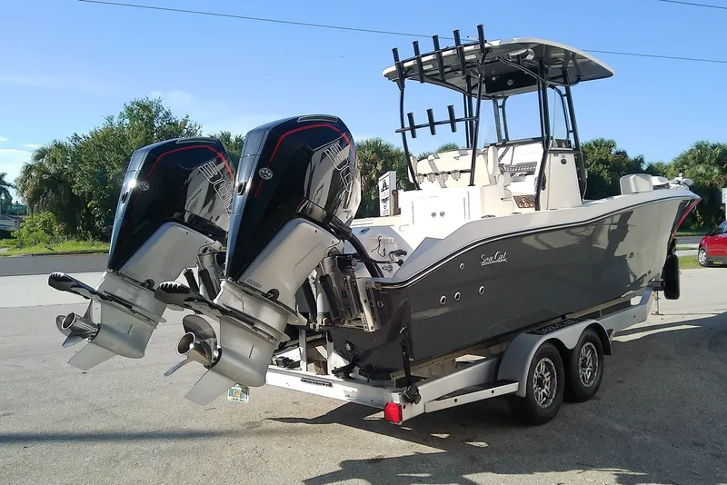 Slide: The Image of 2022 Sea Cat 260 boat with dual outboard motors on a trailer. - 3