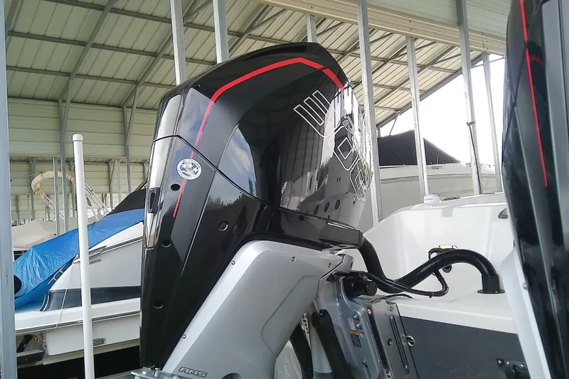 Slide: The Image of A modern outboard motor on a Sea Cat 260 boat in a covered area. - 16