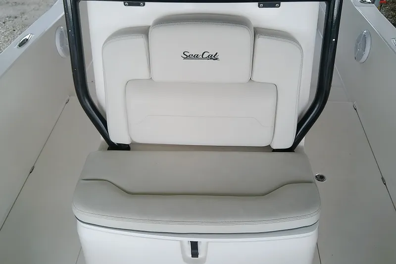 Slide: The Image of 2022 Sea Cat 260 boat interior with white cushioned seating and black frame. - 40
