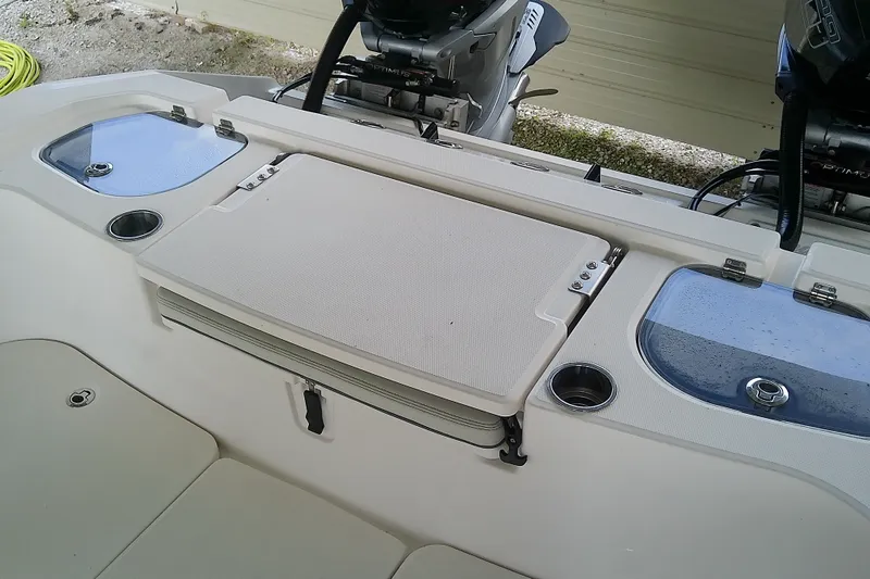 Slide: The Image of 2022 Sea Cat 260 boat interior with storage compartments and cup holders. - 45