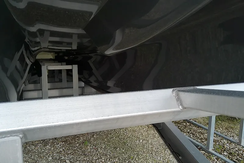 Slide: The Image of Underside view of a 2022 Sea Cat 260 boat on a metal trailer. - 7