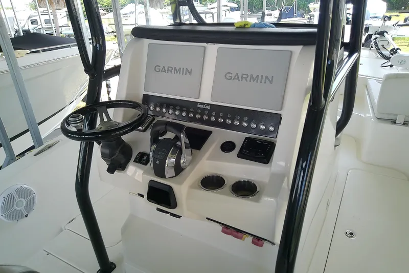 Slide: The Image of 2022 Sea Cat 260 boat console with Garmin navigation system and steering wheel. - 61