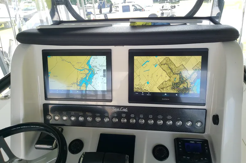 Slide: The Image of Dashboard of 2022 Sea Cat 260 boat with dual Garmin navigation screens. - 64