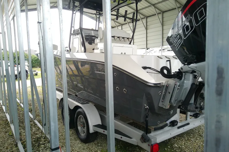 Slide: The Image of 2022 Sea Cat 260 boat on trailer in covered storage area. - 24