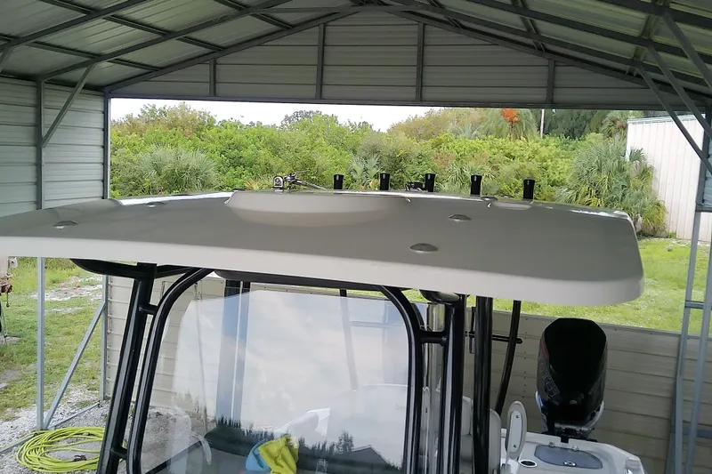 Slide: The Image of 2022 Sea Cat 260 boat under shelter, showcasing its sturdy roof and sleek design. - 35