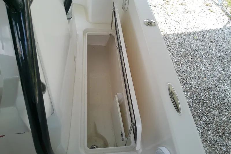 Slide: The Image of Open storage compartment on a 2022 Sea Cat 260 boat, showcasing interior space. - 74