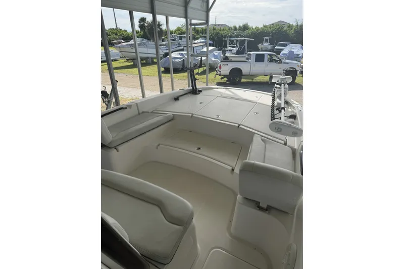 Slide: The Image of 2022 Sea Cat 260 boat interior with seating, parked under a canopy. - 76