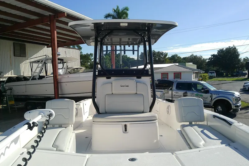 Slide: The Image of 2022 Sea Cat 260 boat with seating, parked outdoors under a metal roof. - 13