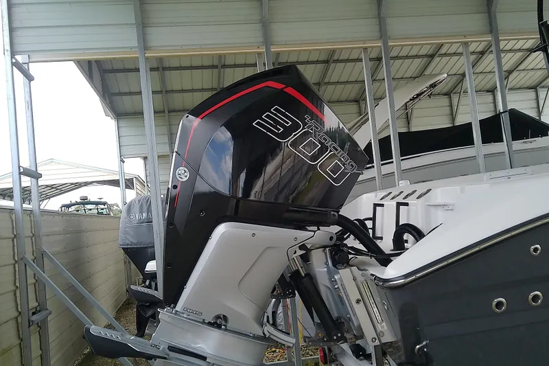 Slide: The Image of A powerful outboard motor on a Sea Cat 260 boat, under a covered area. - 12
