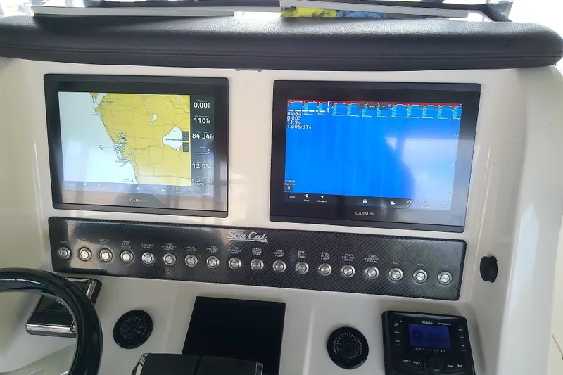 Slide: The Image of Control panel of a 2022 Sea Cat 260 boat with dual Garmin displays. - 66