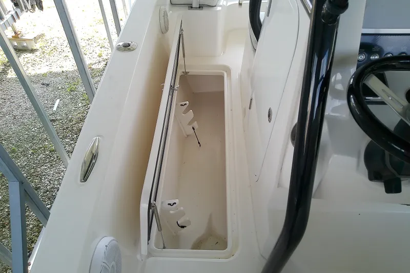 Slide: The Image of 2022 Sea Cat 260 boat interior with open storage compartment and steering wheel. - 73