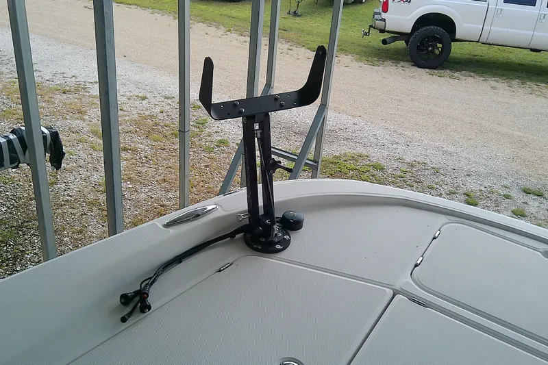 Slide: The Image of 2022 Sea Cat 260 boat deck with mounted fishing rod holder, parked near a white truck. - 37