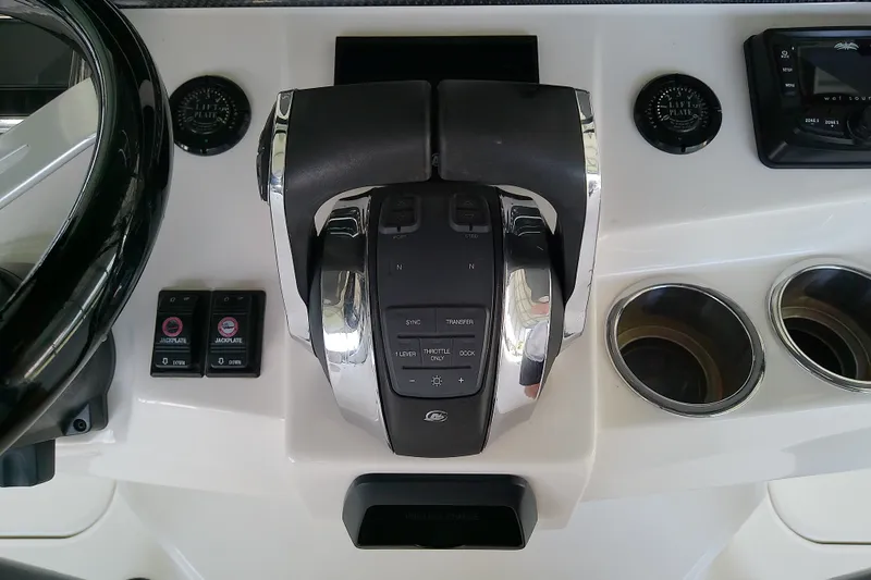 Slide: The Image of Control panel of a 2022 Sea Cat 260 boat with throttle and cup holders. - 68