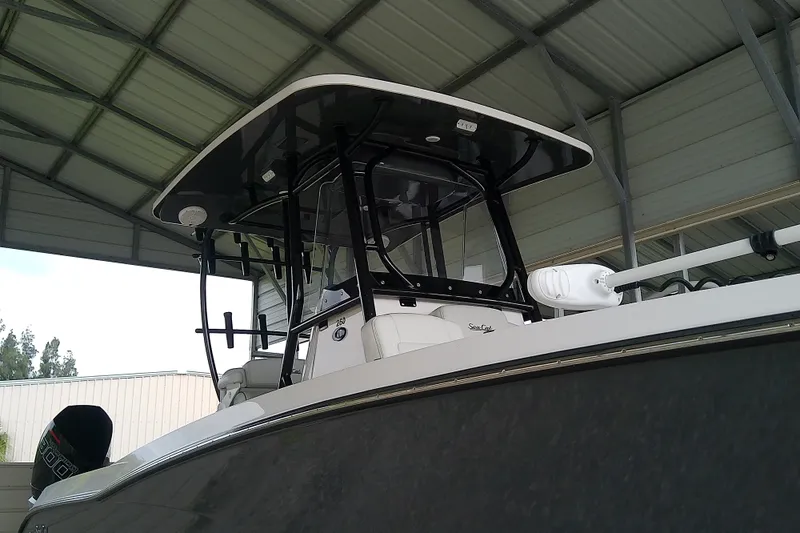Slide: The Image of 2022 Sea Cat 260 boat under a metal canopy, showcasing sleek design and modern features. - 10