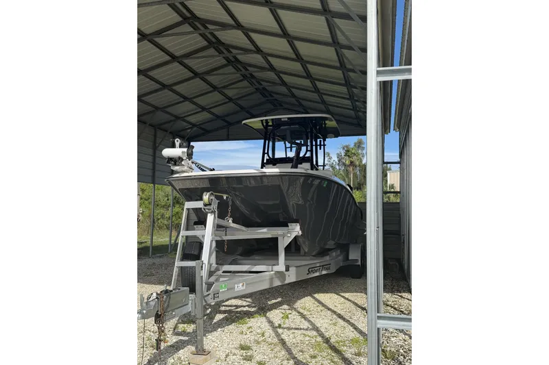Slide: The Image of 2022 Sea Cat 260 boat on trailer under metal shelter. - 4