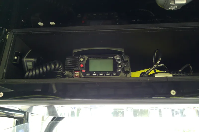 Slide: The Image of Marine radio equipment inside a 2022 Sea Cat 260 boat compartment. - 71