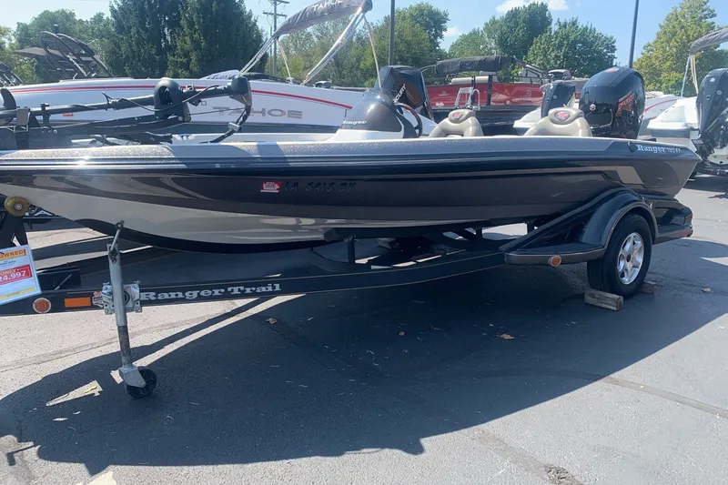The Image of 2005 Ranger 185 VX boat on trailer, parked outdoors, with trees in the background. - 0